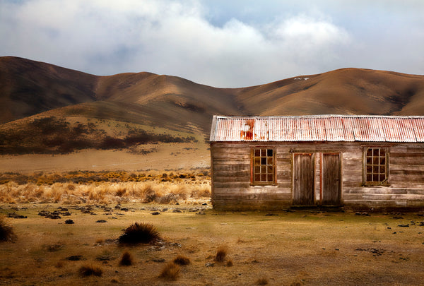 A landscape photograph of an old wooden farm building with an iron roof, set in a dry, grassy field with Maniototo hills in the background, won a bronze award in the National Iris Photography awards.