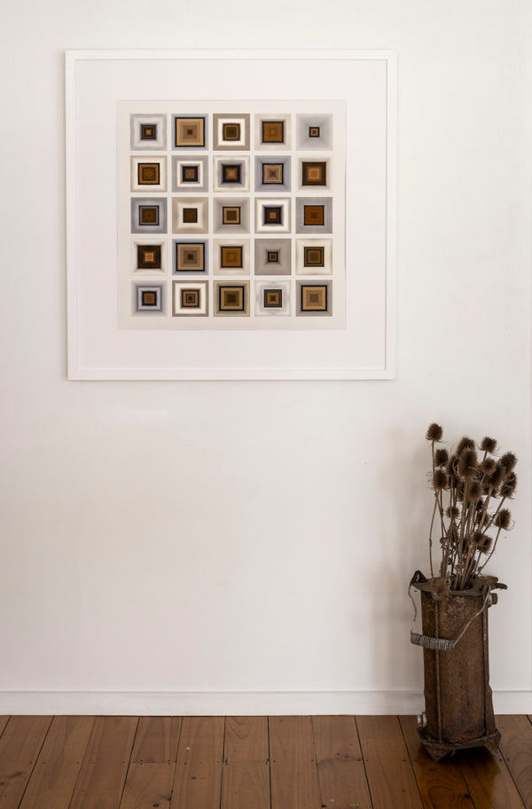 In room image of finished framed limited edition print titled 'Inbound Snow' featuring a geometric array of squares with varying shades of brown and white, designed to represent the effect of an incoming snowstorm.