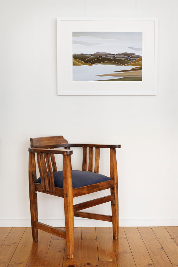 In room image of framed Landscape print inspired by the Loganburn Dam (Moss Swamp), Central Otago and reflecting the influence of New Zealand printmaker, Marilyn Webb, using simplified lines and muted colours