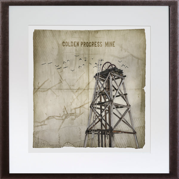 Framed artwork of a mine tower with 'Golden Progress Mine' text on a textured background